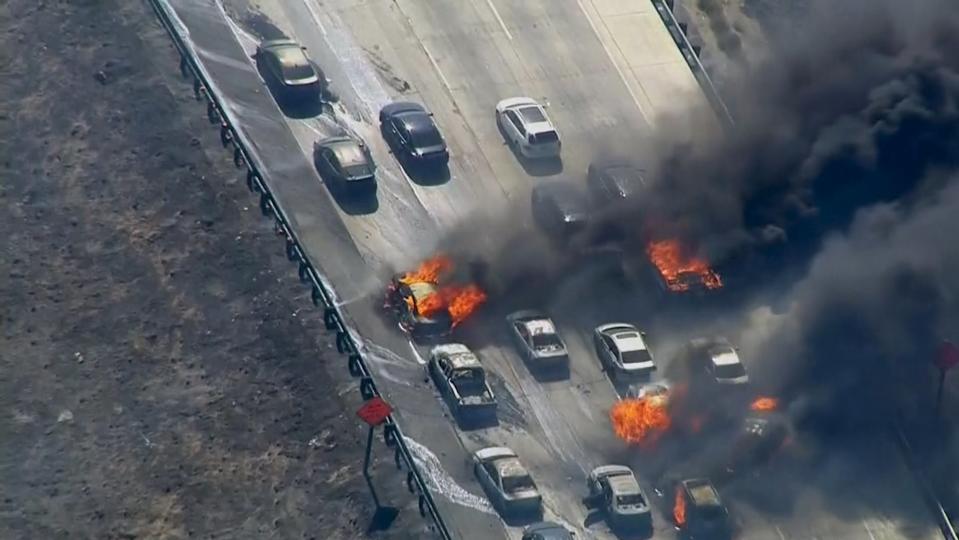 Frame grab from video of cars burning on Interstate 15 during a brush fire in the Cajon Pass, California