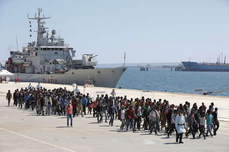 Migrants are disembarked from the Italian navy ship Vega in the Sicilian harbour of Augusta, southern Italy, May 4, 2015. REUTERS/Antonio Parrinello