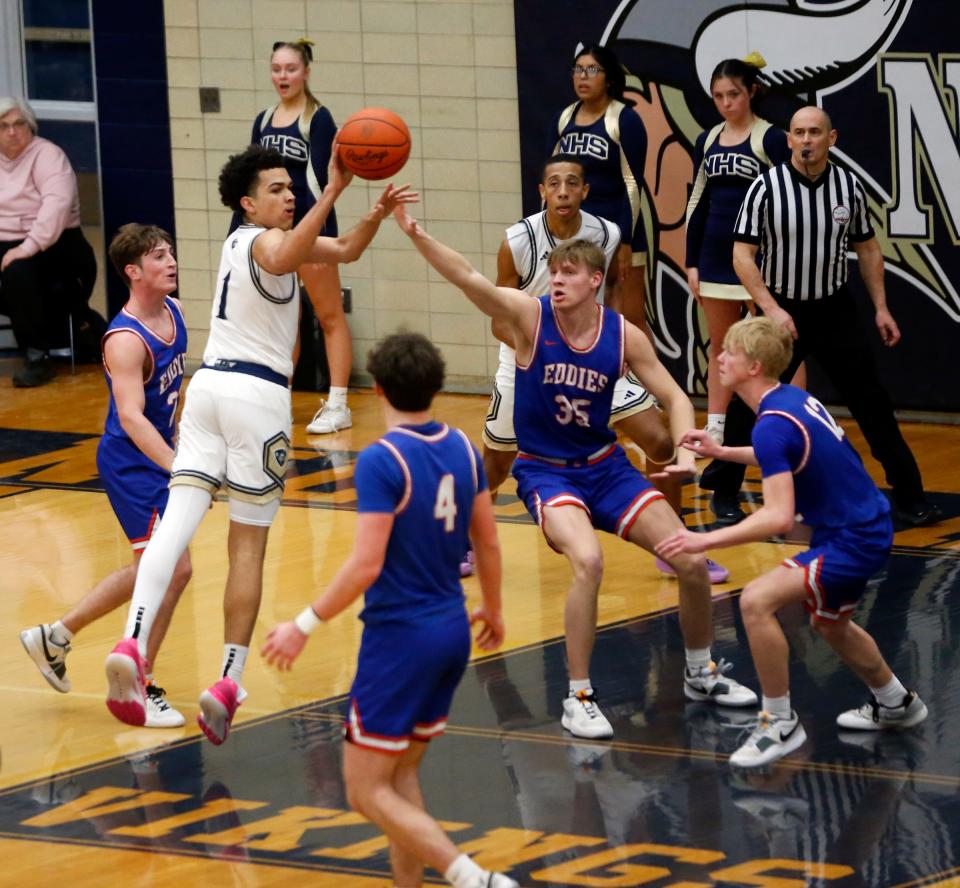 Niles sophomore Brayden Flowers (1) makes a pass while surrounded by four Edwardsburg players during a boys basketball game Wednesday, Jan. 17, 2024, at Niles High School.