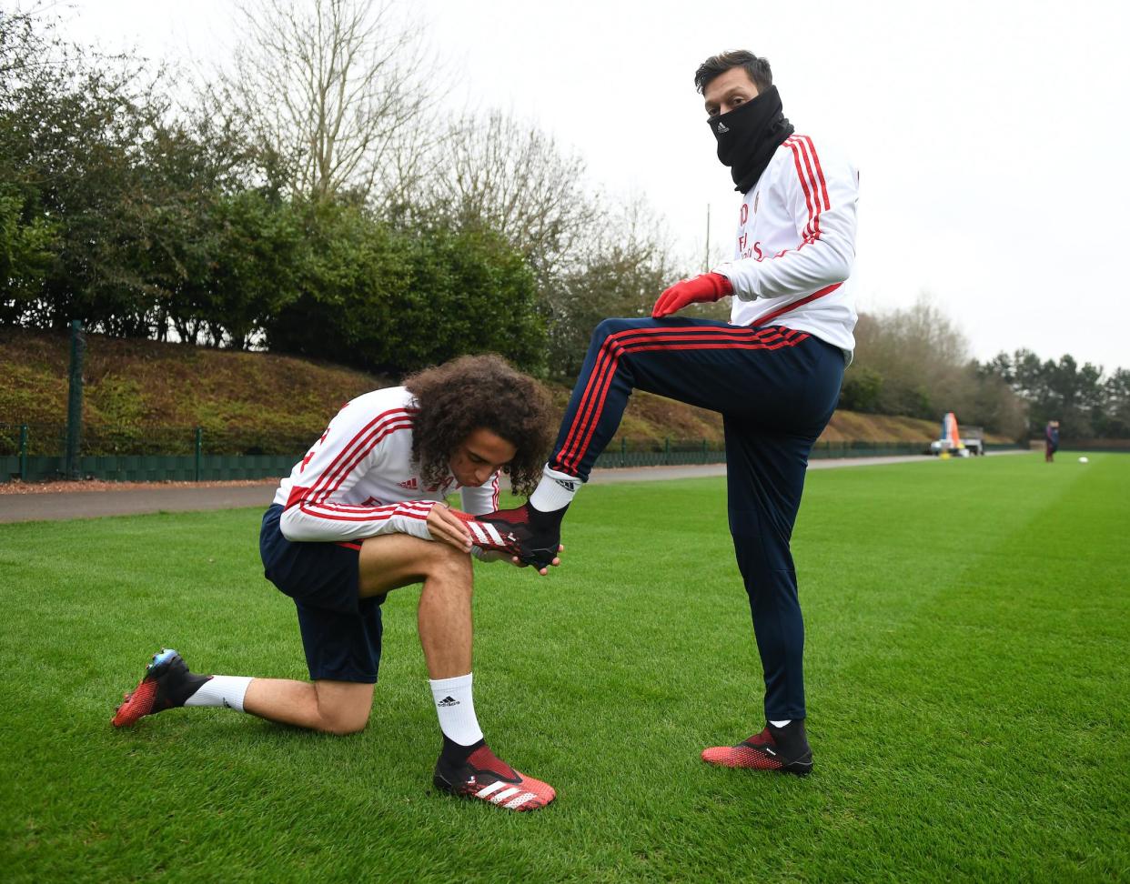 Matteo Guendouzi kisses (R) Mesut Ozil's new adidas predator boot before a training session at London Colney on January 24, 2020 in St Albans, England: Stuart MacFarlane/Arsenal FC via Getty Images