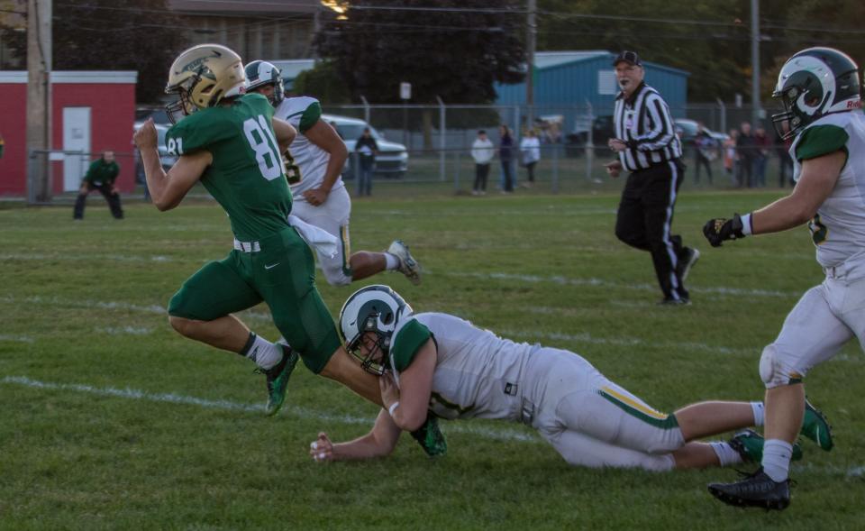 Carson Kinsey of St. Mary Catholic Central is tackled by Flat Rock's Robert Percha during a 20-14 SMCC win Friday night. [Provided by STEPHANIE HAWKINS]