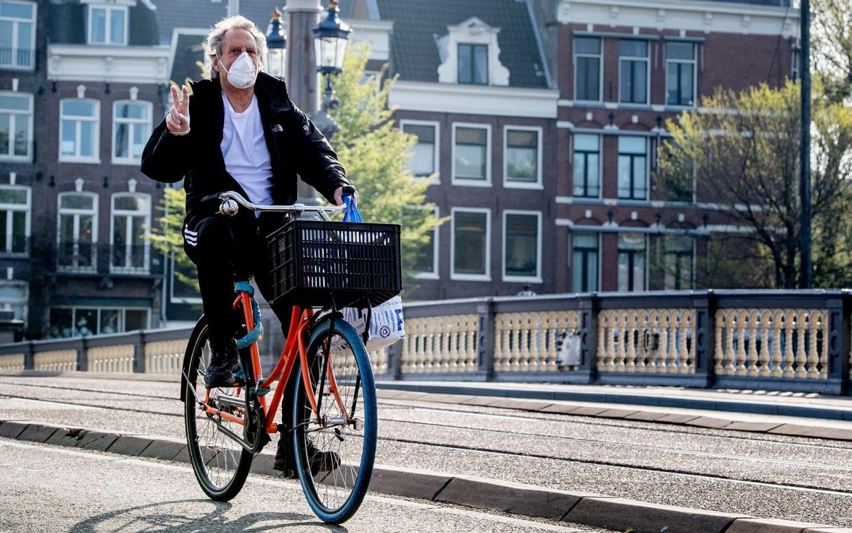 A Dutch cyclist wears a face mask to protect himself from coronavirus. Infections have risen in the Netherlands - SOPA Images 