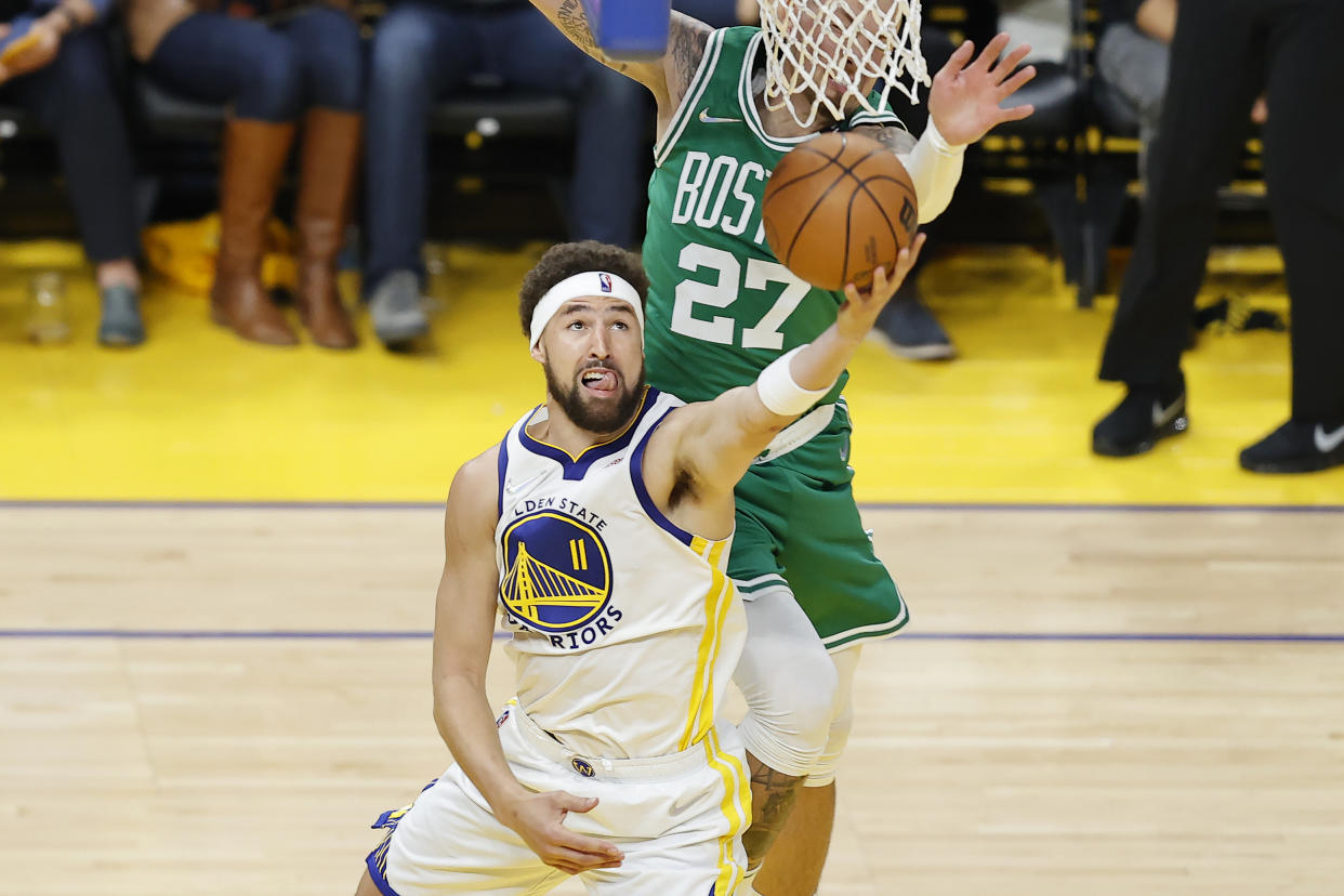 Golden State Warriors guard Klay Thompson (11) shoots against Boston Celtics center Daniel Theis (27) during the first half of Game 1 of basketball's NBA Finals in San Francisco, Thursday, June 2, 2022. (AP Photo/John Hefti)