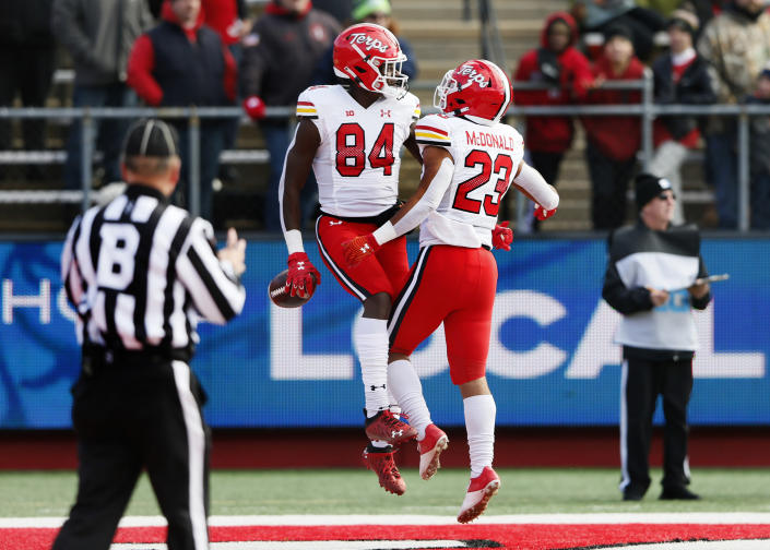 Maryland tight end Corey Dyches (84) celebrates with running back Colby McDonald (23) after scoring a touchdown against Rutgers during the first half of an NCAA football game, Saturday, Nov. 27, 2021, in Piscataway, N.J. (AP Photo/Noah K. Murray)