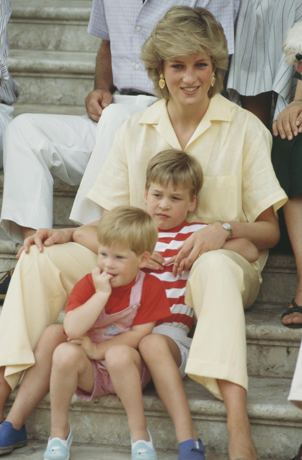 <p>William and Harry sitting with their mother Diana during a holiday with the Spanish royal family at the Marivent Palace in Palma de Mallorca, Spain, in August 1987. (Getty Images)</p> 