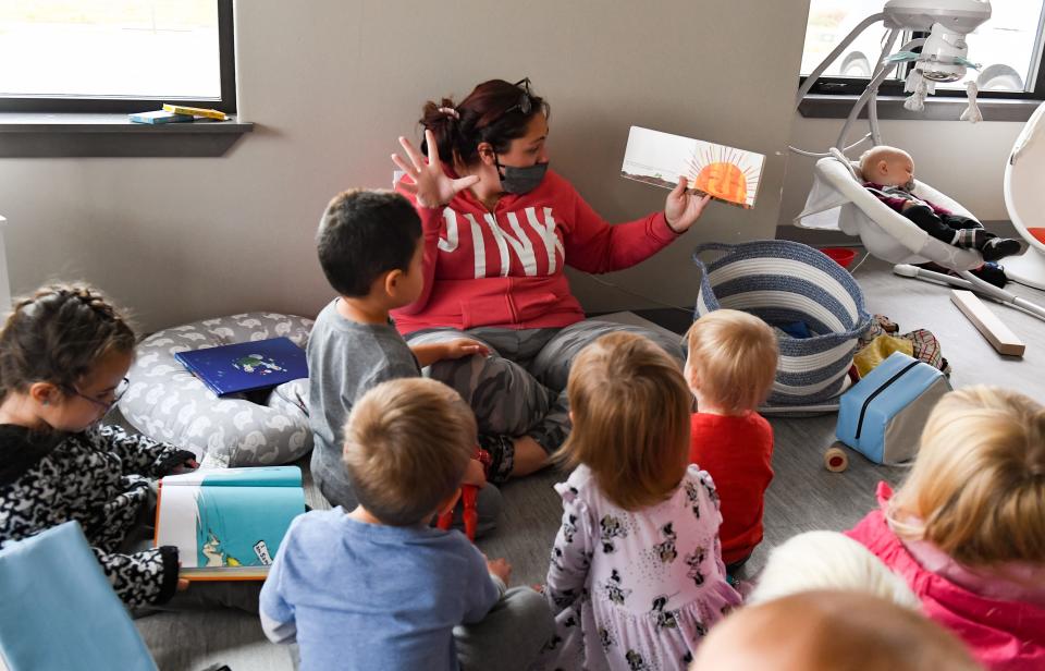 Alexis Sherman reads "The Very Hungry Caterpillar" to a group of children on Tuesday, October 26, 2021, at Little Tykes University in Sioux Falls.