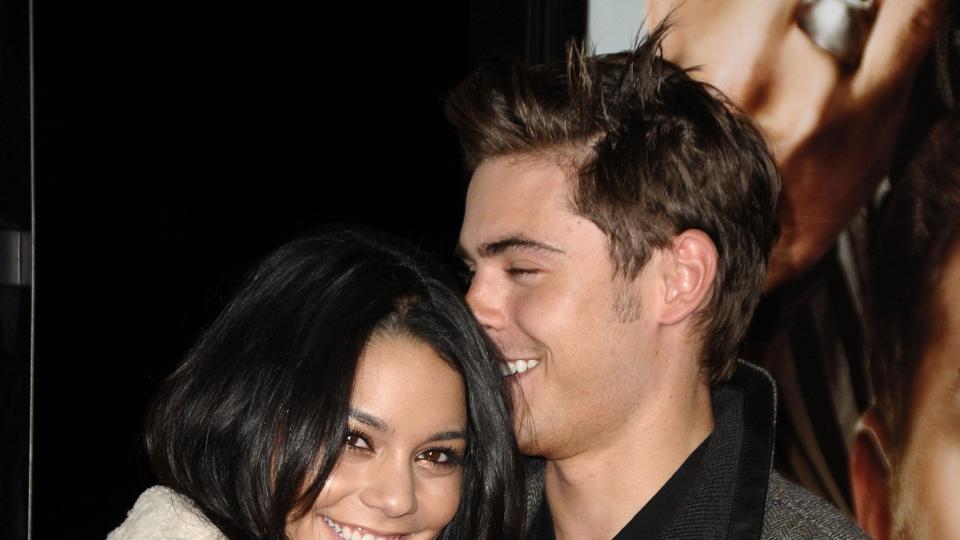 Zac Efron and Vanessa Hudgens smiling and hugging each other