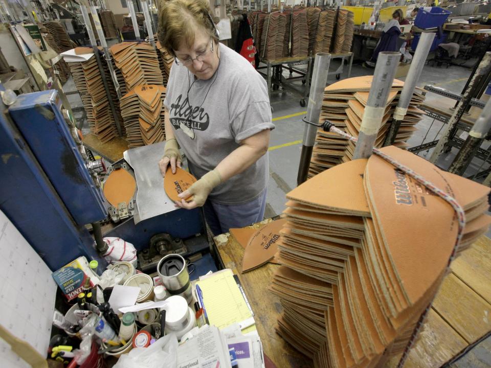 Loretta Hicks stamps the Wilson logo into footballs at the Wilson Sporting Goods football factory in Ada, Ohio