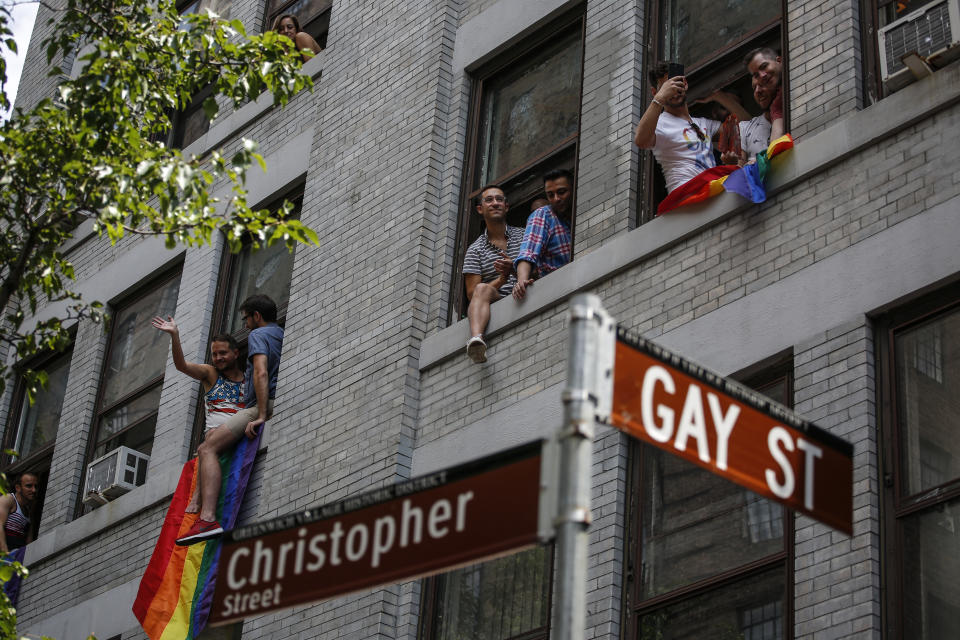 <p>Revelers watch the annual Pride Parade from windows on June 24, 2018 in New York City. (Photo: Kena Betancur/Getty Images) </p>