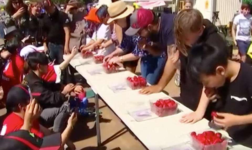 Bundaberg residents chow down on fruit at a strawberry festival to get behind farmers during the ongoing crisis. Source: 7 News