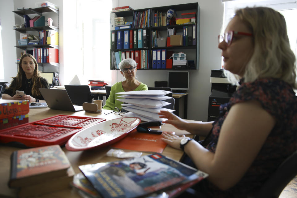 Hannah Miller, left, Helise Lieberman, center, and Marta Saracyn speak during an interview with The Associated Press, at the Lauder Morasha Jewish school in Warsaw, Poland, Thursday, July 28, 2022. A special summer camp run by Jewish organizations has brought Jewish volunteers from the former Soviet Union to Warsaw to help Ukrainian children. The camp, which ran for most of July and ended Friday, was organized to bring some joy to traumatized children, help prepare them for the school year ahead in Polish schools and give their mothers some time to themselves. (AP Photo/Michal Dyjuk)