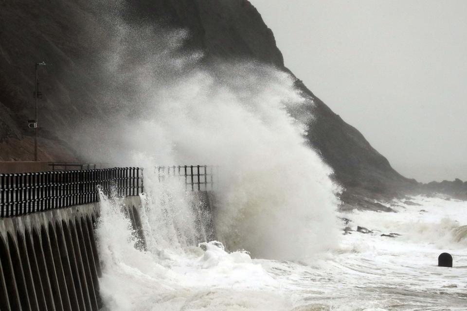 Large waves crash over the promenade in Folkestone, Kent (PA)