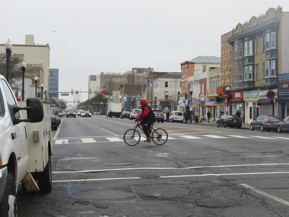 A bicyclist rides across Atlantic Avenue in Atlantic City, N.J. on Jan. 26, 2024. Several casinos and a hospital wanted a judge to block the city's plan to reduce the width of the street, the main artery through Atlantic City's downtown, from four lanes to two. But on Jan. 24, 2024 the judge refused to do so. (AP Photo/Wayne Parry)