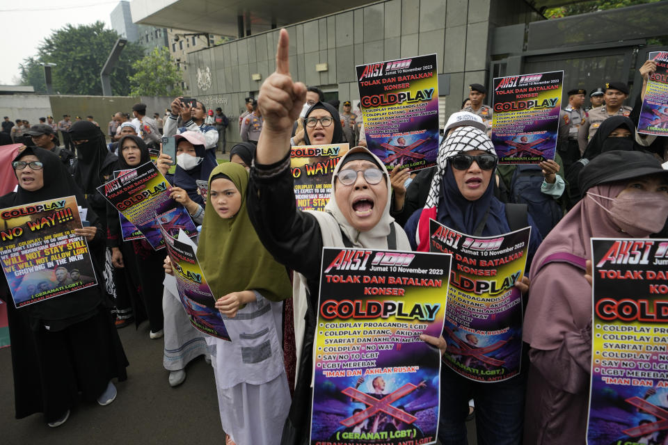 Muslims shout slogans during a rally against British band Coldplay outside the British embassy in Jakarta, Indonesia, Friday, Nov. 10, 2023. Dozens of conservative Muslims marched in Indonesia's capital on Friday calling for cancellation of Coldplay's concert later this month, saying the British band's support of lesbian, gay, bisexual, and transgender will corrupt young people. (AP Photo/Achmad Ibrahim)