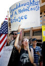 <p>Protesters outside the Phoenix Convention Center hold up signs and shout back at President Donald Trump supporters waiting to enter a rally by Trump on August 22, 2017 in Phoenix, Arizona. (Ralph Freso/Getty Images) </p>