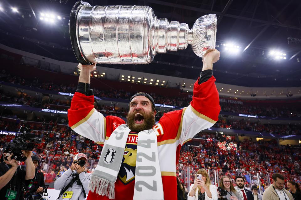 Jun 24, 2024; Sunrise, Florida, USA; Florida Panthers defenseman Aaron Ekblad (5) hoists the Stanley Cup after defeating Edmonton Oilers in game seven of the 2024 Stanley Cup Final at Amerant Bank Arena. Mandatory Credit: Sam Navarro-USA TODAY Sports