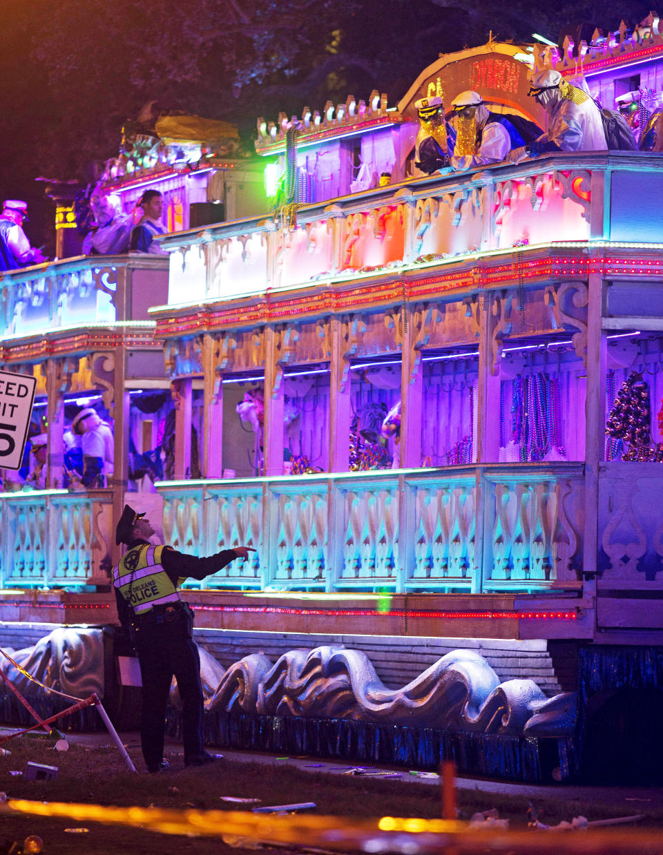 A police officer works the scene where a man was reportedly hit and killed by a float of the Krewe of Endymion parade in the runup to Mardi Gras in New Orleans, Saturday, Feb. 22, 2020. A person was struck by a float and fatally injured Saturday evening during one of the iconic parades of the Mardi Gras season in New Orleans, authorities said. It was the second death in days to mar this year's Carnival festivities. (Max Becherer/The Advocate via AP)