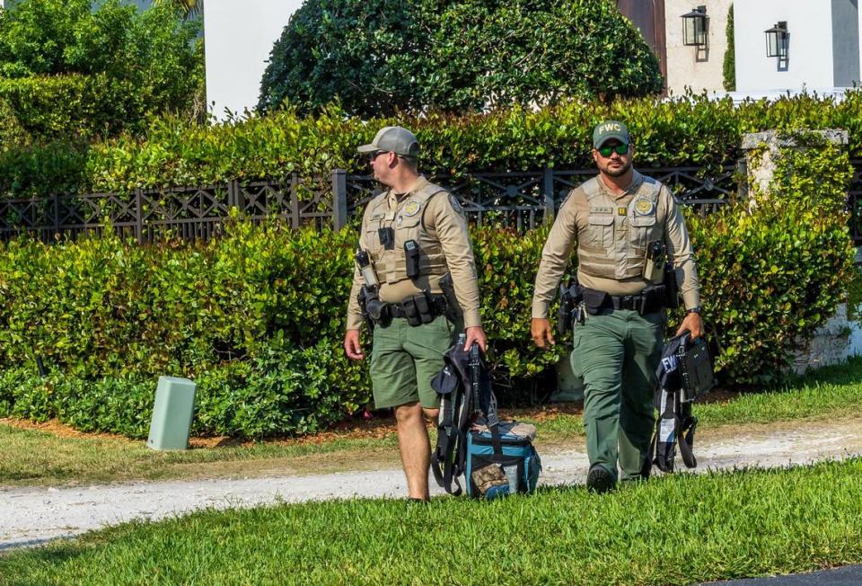 Florida Fish and Wildlife Conservation Commission officers exit the Coral Gables home at 11025 Tanya St., where police say a boat matching the description of the vessel that struck and killed Ella Adler near Nixon Beach Sandbar on Saturday was seized in Coral Gables, on Tuesday, May 14, 2024.