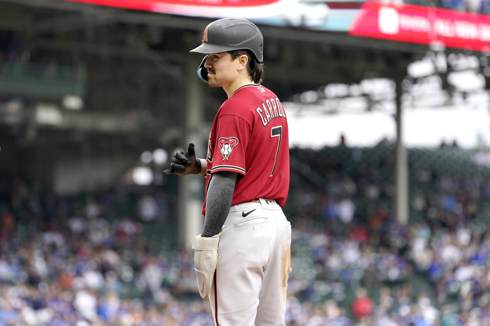 Arizona Diamondbacks' Corbin Carroll reacts toward teammates after his flyout was overturned after video review to an RBI single during the eighth inning of a baseball game against the Chicago Cubs, Friday, Sept. 8, 2023, in Chicago. (AP Photo/Charles Rex Arbogast)