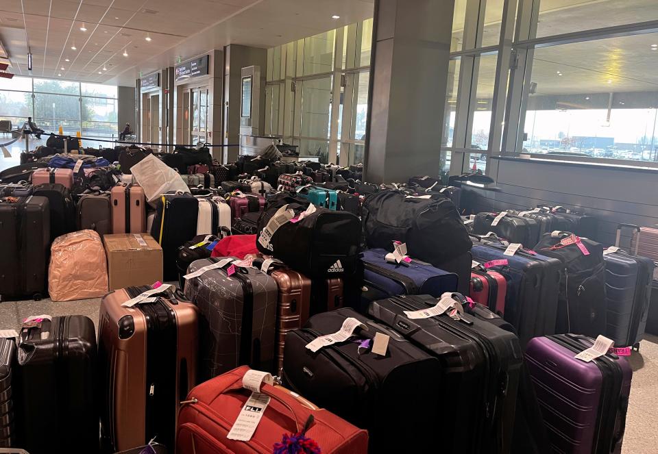 Suitcases had accumulated by Tuesday, Dec. 27, 2022, near the baggage claim area in the Sacramento International Airport, in Sacramento, Calif., after Southwest Airlines flight cancellations led luggage to arrive before passengers with holiday travel plans.