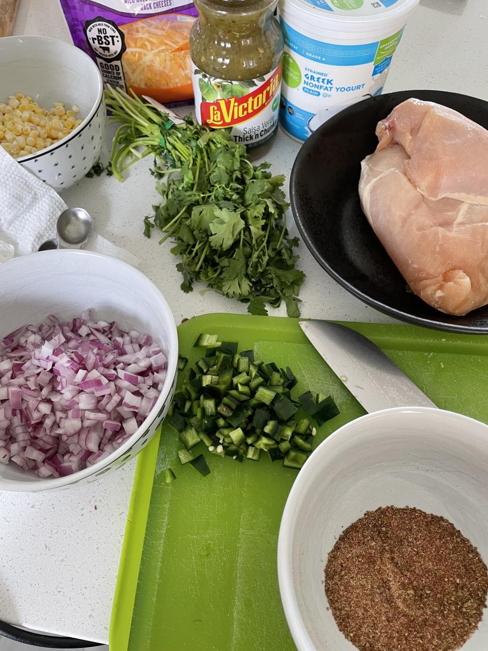 Vegetables prepped and a spice blend in a bowl on the counter