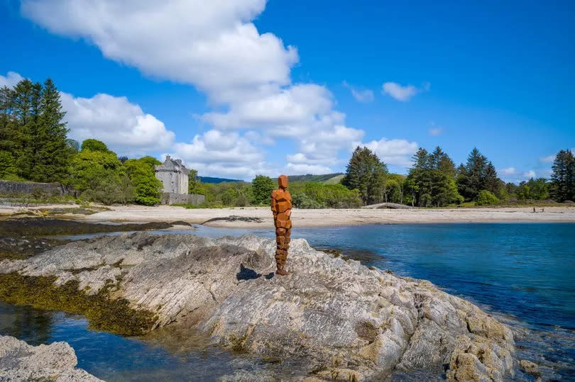 KINTYRE, SCOTLAND, UNITED KINGDOM: Antony Gormley sculpture GRIP of an abstract human form looking out over Saddell Bay, Kilbrannan Sound to Arran, Saddell Castle in background in Kintyre, Scotland"n.  (Photo by Tim Graham/Getty Images)