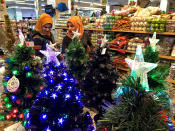 Iraqis shop for Christmas decorations in Baghdad, Iraq, Monday, Dec. 24, 2018. Although the number of Christians has dropped in Iraq, Christmas a national holiday, is very popular in the capital. (AP Photo/Ali Abdul Hassan)