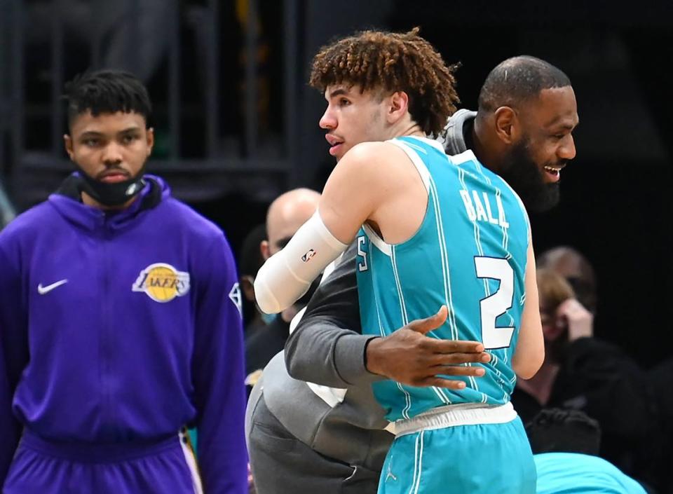 Charlotte Hornets guard LaMelo Ball, left, is hugged by the Los Angeles Lakers’ LeBron James during a break in the action at Spectrum Center in Charlotte, NC on Friday, January 28, 2022. James did not play due to left knee soreness. Ball had 20 points and seven rebounds in Charlotte’s 117-114 win.