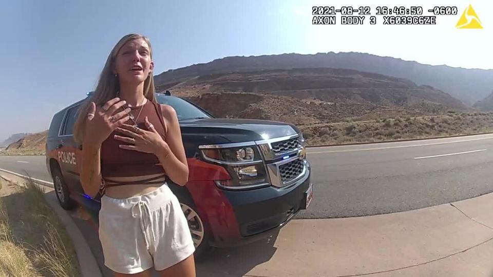 Gabby Petito is seen talking to a Moab, Utah, police officer after police pulled over the van she was traveling in with fiancé Brian Laundrie near the entrance to Arches National Park on August 12, 2021.  / Credit: Moab Police Department