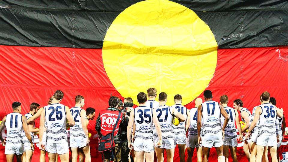 Pictured here, players walk out for a match during the AFL's Indigenous Round.