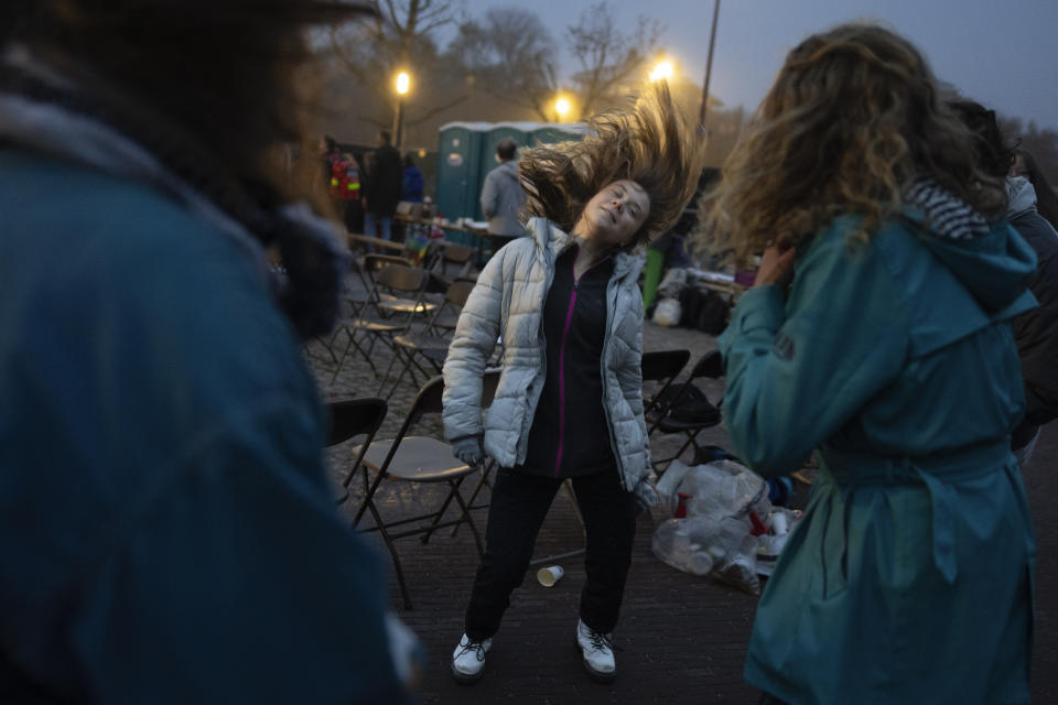 Climate activist Greta Thunberg dances after addressing tens of thousands of people who marched through Amsterdam, Netherlands, Sunday, Nov. 12, 2023, to call for more action to tackle climate change. Thunberg was among the speakers at the march that comes 10 days before national elections in the Netherlands. (AP Photo/Peter Dejong)