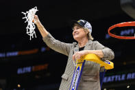 Iowa head coach Lisa Bluder holds up a net during a victory celebration after an Elite 8 college basketball game of the NCAA Tournament against Louisville, Sunday, March 26, 2023, in Seattle. (AP Photo/Caean Couto)