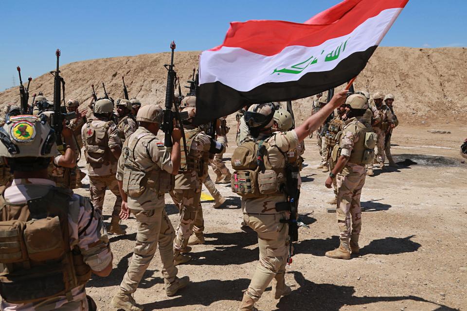 Iraqi soldiers chant slogans against IS while Australian and New Zealand coalition forces participate in a training mission with Iraqi army soldiers at Taji Base, north of Baghdad, Iraq, Wednesday, April 17, 2019. A month after the defeat of the Islamic State group in Syria and Iraq, the U.S.-led international coalition has turned its attention to training Iraqi forces to secure the country against lingering threats posed by IS cells operating in the countryside. (AP Photo/Hadi Mizban)