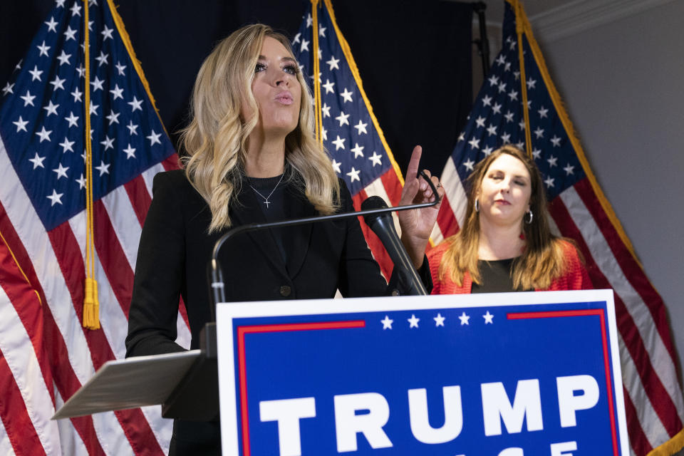 White House press secretary Kayleigh McEnany, left, accompanied by Republican National Committee chairwoman Ronna McDaniel, speaks during a news conference at the Republican National Committee, Monday, Nov. 9, 2020, in Washington. (AP Photo/Alex Brandon)