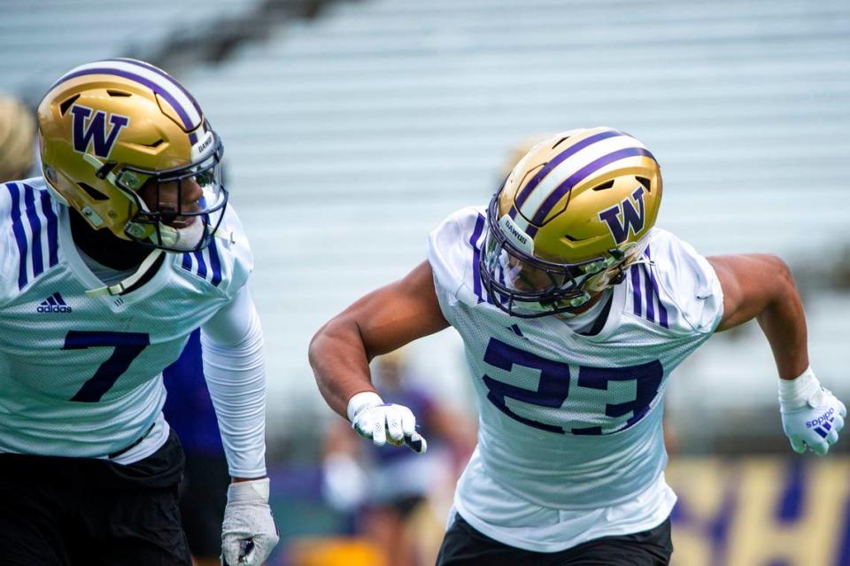 Washington cornerback Mishael Powell (23) runs through drills with Dominique Hampton at spring practice on Wednesday, March 30, 2022, at Husky Stadium in Seattle, Wash.