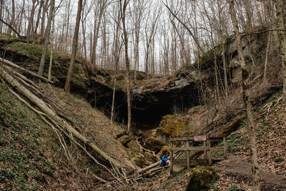 A woman returns to the trail Friday at Hosak's Cave at Salt Fork State Park. Located in eastern Ohio, Salt Fork is the largest state park in Ohio, covering 17,229 acres of land and 2,952 acres of water, according to the Ohio Department of Natural Resources.