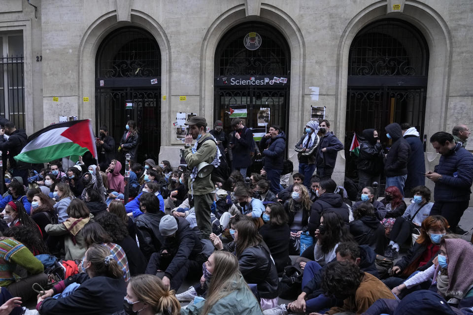 Students stage a sit in in front of Sciences-Po university in Paris Friday, April 26, 2024. Students in Paris inspired by Gaza solidarity encampments at campuses in the United States blocked access to a campus building at a prestigious French university Friday, prompting administrators to move all classes online. The pro-Palestinian protest at the Paris Institute of Political Studies, known as Sciences Po, came two days after police broke up a separate demonstration at one of the university's amphitheaters. (AP Photo/Michel Euler)