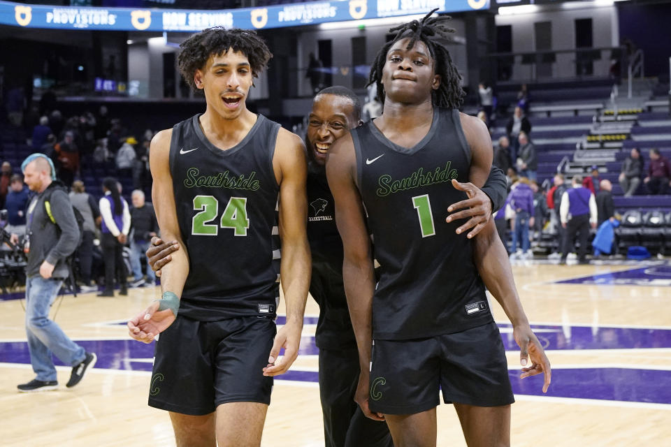 Chicago State assistant coach Jelani Hewitt, center, celebrates with guard Jahsean Corbett, left, and guard Wesley Cardet Jr., after Chicago State defeated No. 24 Northwestern 75-73 in an NCAA college basketball game in Evanston, Ill., Wednesday, Dec. 13, 2023. (AP Photo/Nam Y. Huh)