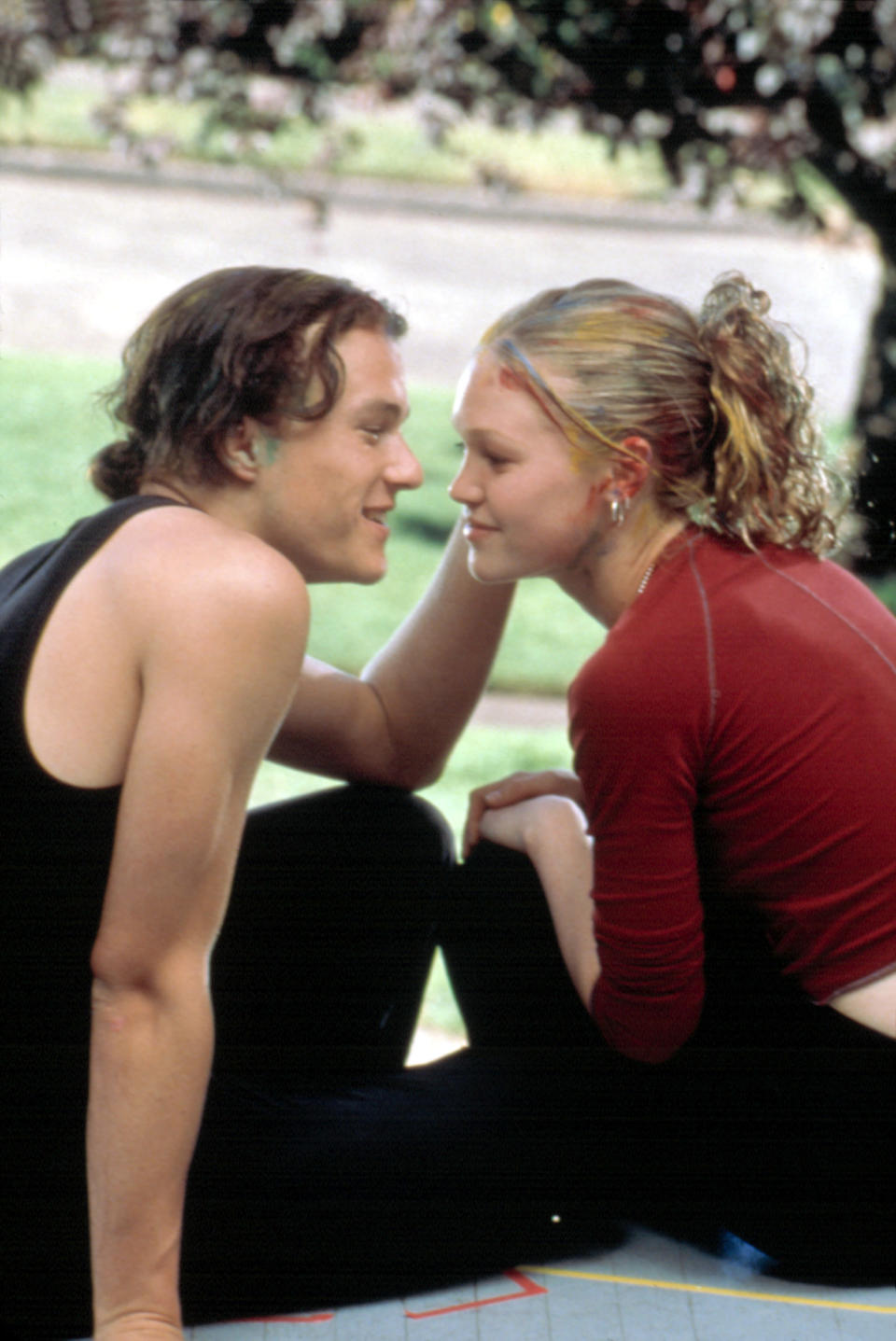 Heath Ledger grazes Julia Stiles' cheek with his hand and gazes lovingly into her eyes in a scene from "10 Things I Hate About You"