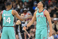 San Antonio Spurs' Keldon Johnson (3) celebrates after a basket with teammate Blake Wesley during the second half of an NBA basketball game against the Memphis Grizzlies, Friday, March 17, 2023, in San Antonio. (AP Photo/Darren Abate)