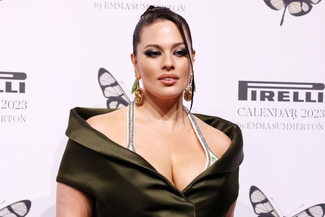 Ashley Graham's boobs nearly POP OUT as she bounces on bed in