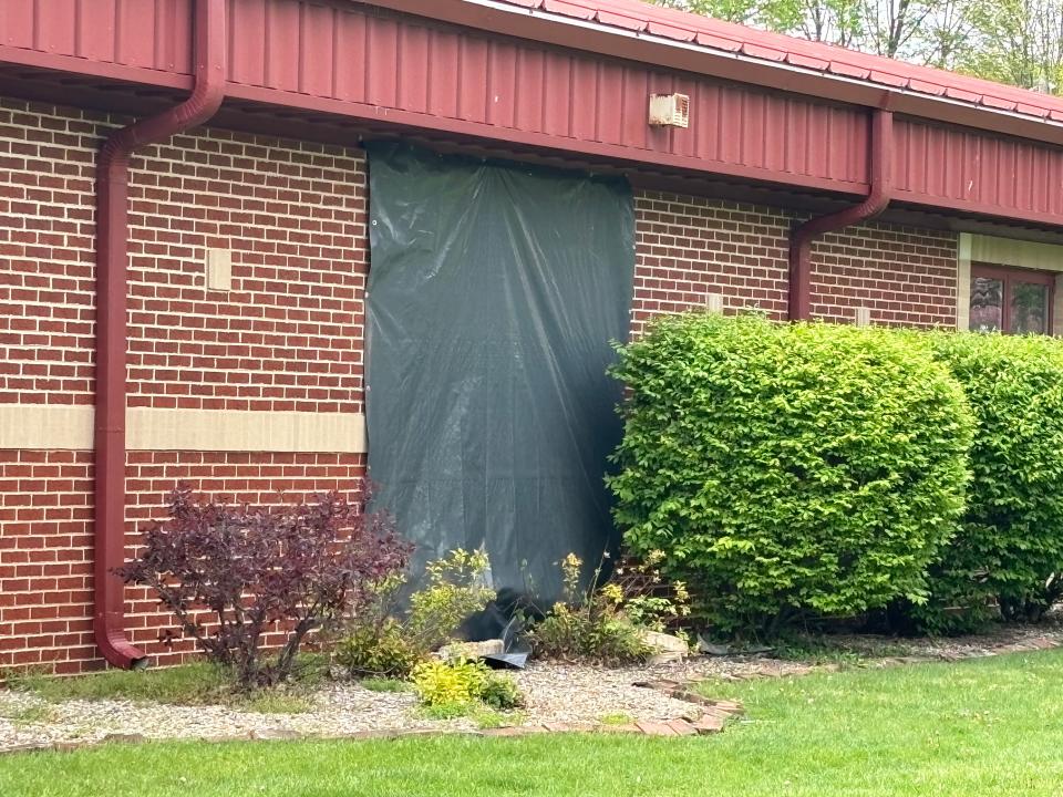 A tarp covers damage to a classroom at Waverly High School on April 19, 2024. A week before, a driver crashed into the school to avoid deer and dogs he claimed were in the street. A school official said there is no dollar figure on the damage yet.