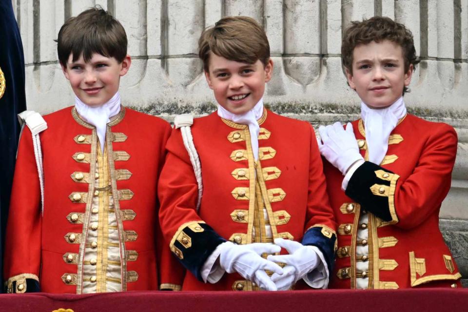 <p>Samir Hussein/WireImage</p> Lord Oliver Cholmondeley, Prince George and Nicholas Barclay on the balcony of Buckingham Palace on King Charles and Queen Camilla