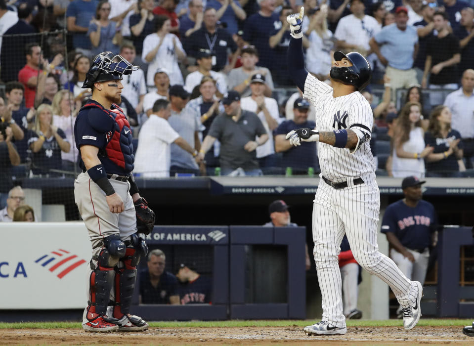 New York Yankees' Gleyber Torres, right, celebrates after hitting a grand slam, next to Boston Red Sox catcher Christian Vazquez during the first inning of a baseball game Friday, Aug. 2, 2019, in New York. (AP Photo/Frank Franklin II)