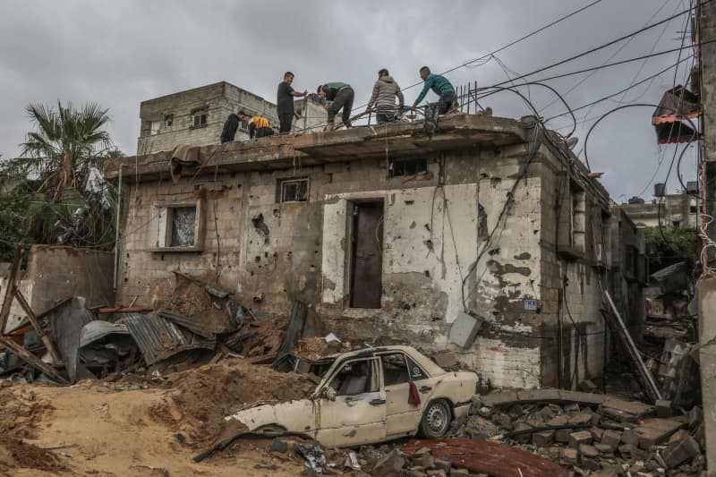 Palestinians inspect a damaged house after Israeli warplanes bombed buildings in Rafah. Abed Rahim Khatib/dpa