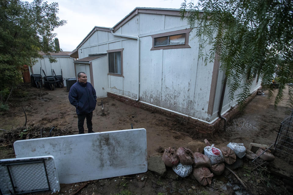 WEST HILLS, CA-February 8, 2024:Walter Rivas, 42, stands in back of his modular home in West Hills that was damaged as a result of a landslide from all the recent rain. Compounding the situation is the fact that he has no renters insurance because no company would insure him and his family due to their precarious location in a flood and wildfire zone.   (Mel Melcon / Los Angeles Times via Getty Images)