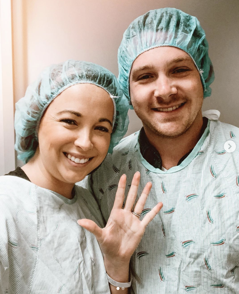 Breanna Lockwood poses with husband AAron in hospital scrubs during IVF attempts