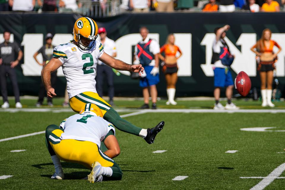 Green Bay Packers kicker Mason Crosby (2) kicks a field goal from he hold of Corey Bojorquez in the second half of an NFL football game against the Cincinnati Bengals in Cincinnati, Sunday, Oct. 10, 2021.