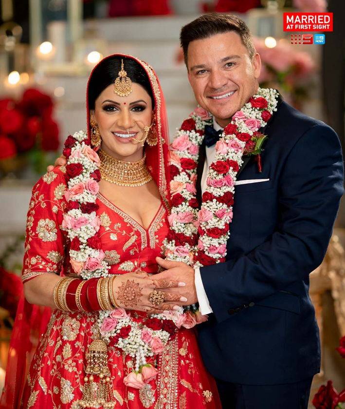 A wedding photo of Sandy and Dan smiling. 