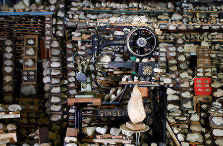 A shoemaking machine is surrounded by the stone collection of Luigi Lineri at his home workshop in Zevio, near Verona, Italy, June 10, 2016. REUTERS/Alessandro Bianchi
